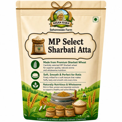 A stand-up pouch of Kisan Kaka MP Select Sharbati Atta on a plain white background. The packaging is beige with green and brown accents, featuring product details, illustrations of wheat, and traditional farming elements.