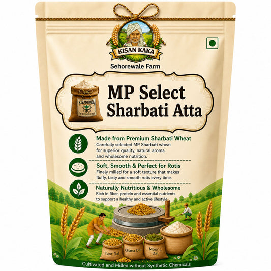 A stand-up pouch of Kisan Kaka MP Select Sharbati Atta on a plain white background. The packaging is beige with green and brown accents, featuring product details, illustrations of wheat, and traditional farming elements.
