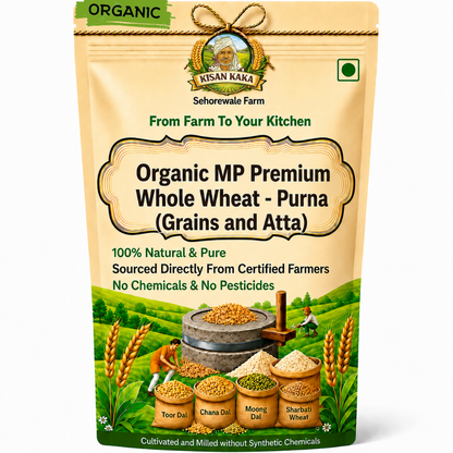 A stand-up pouch of Kisan Kaka Farm Organic MP Premium Whole Wheat - Purna (Grains and Atta) on a plain white background. The packaging is beige with green accents, featuring a logo, product name, and illustrations of wheat, farmers, and a stone grinder.